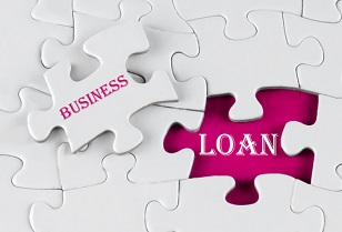 White puzzle with void in the middle when one piece of the puzzle is taken out with text written Business Loan