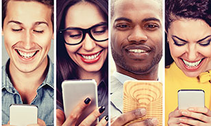 portraits of happy young adults looking at their smartphones
