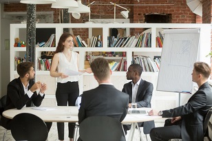 Female business manager coaching a group of employees