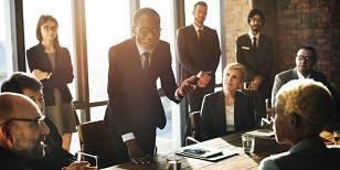 Business leader engaging confidently with his team