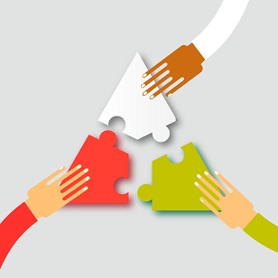 three hands putting together three interlocking puzzle pieces
