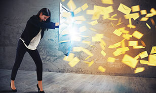 Woman holding up a shield blocking a barrage of spam emails