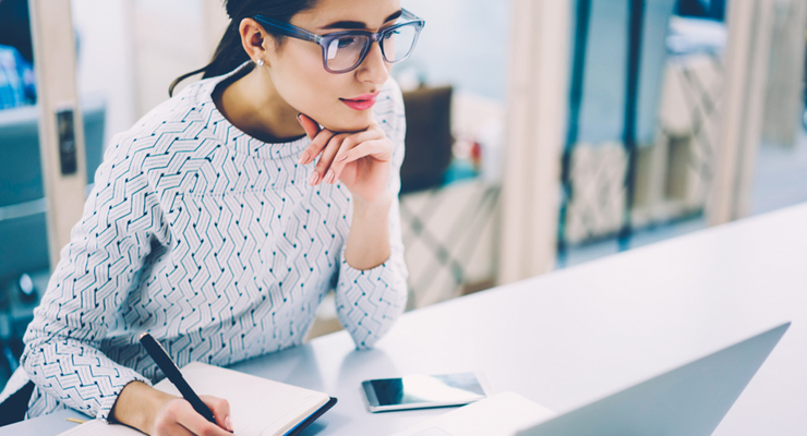 woman watching webinar on laptop