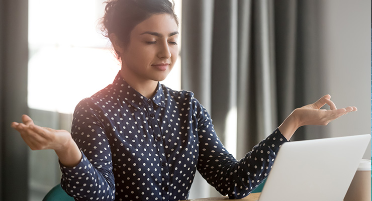 Young woman relaxing at her computer 