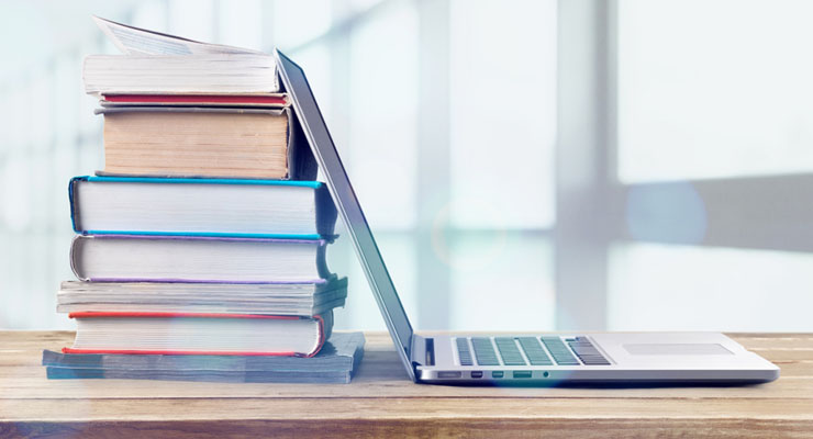Stack of books and laptop