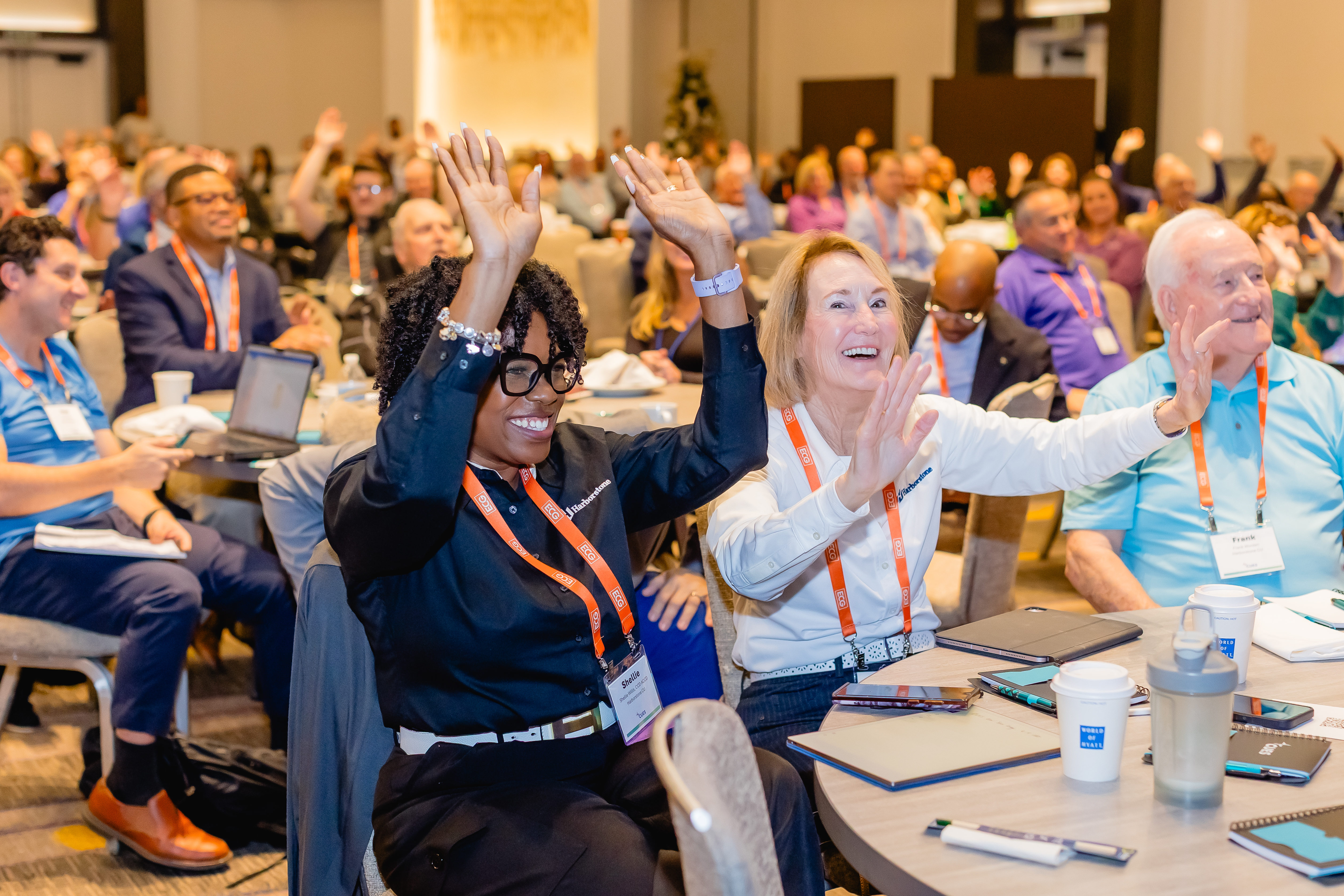 Smiling attendees listening to talk at conference