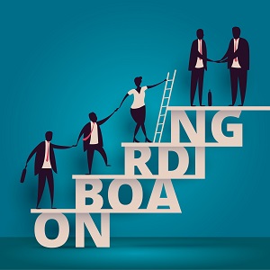 Illustration of businesspeople helping each other climb up a staircase built from the word “onboarding”