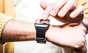A man’s arm wearing an Apple Watch